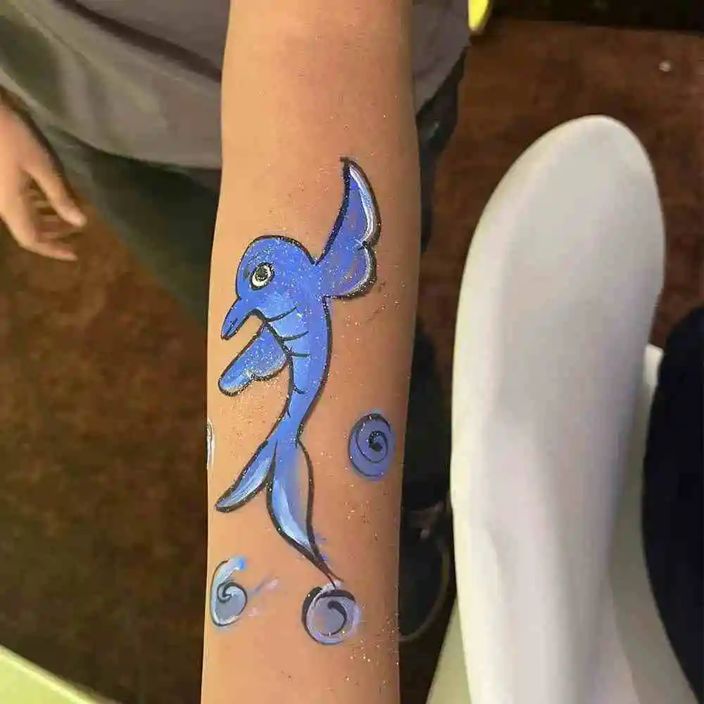 Tattoo Artist Creating Fun Designs at Party Event Setup